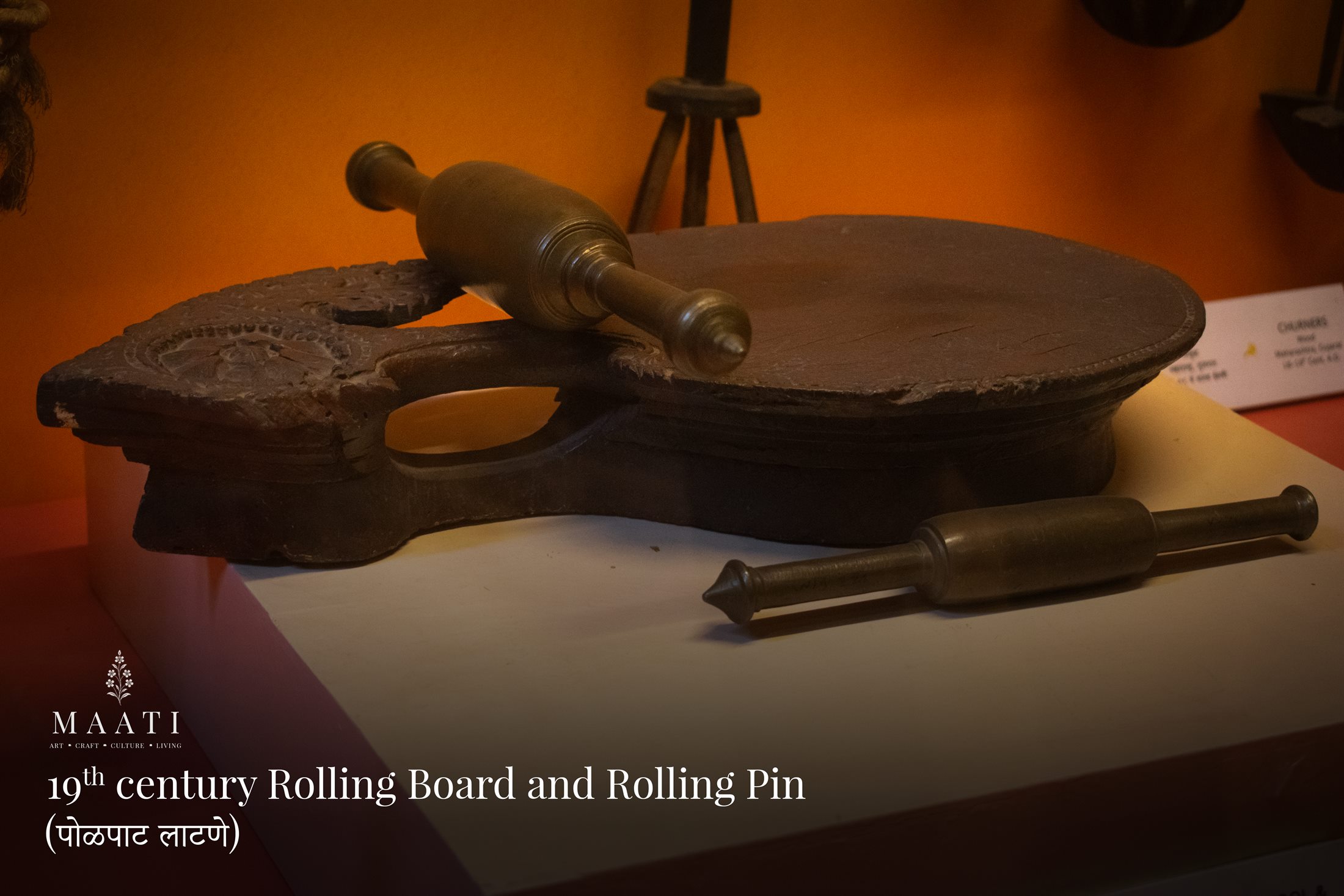 A nineteenth-century rolling board and rolling pin displayed in a museum