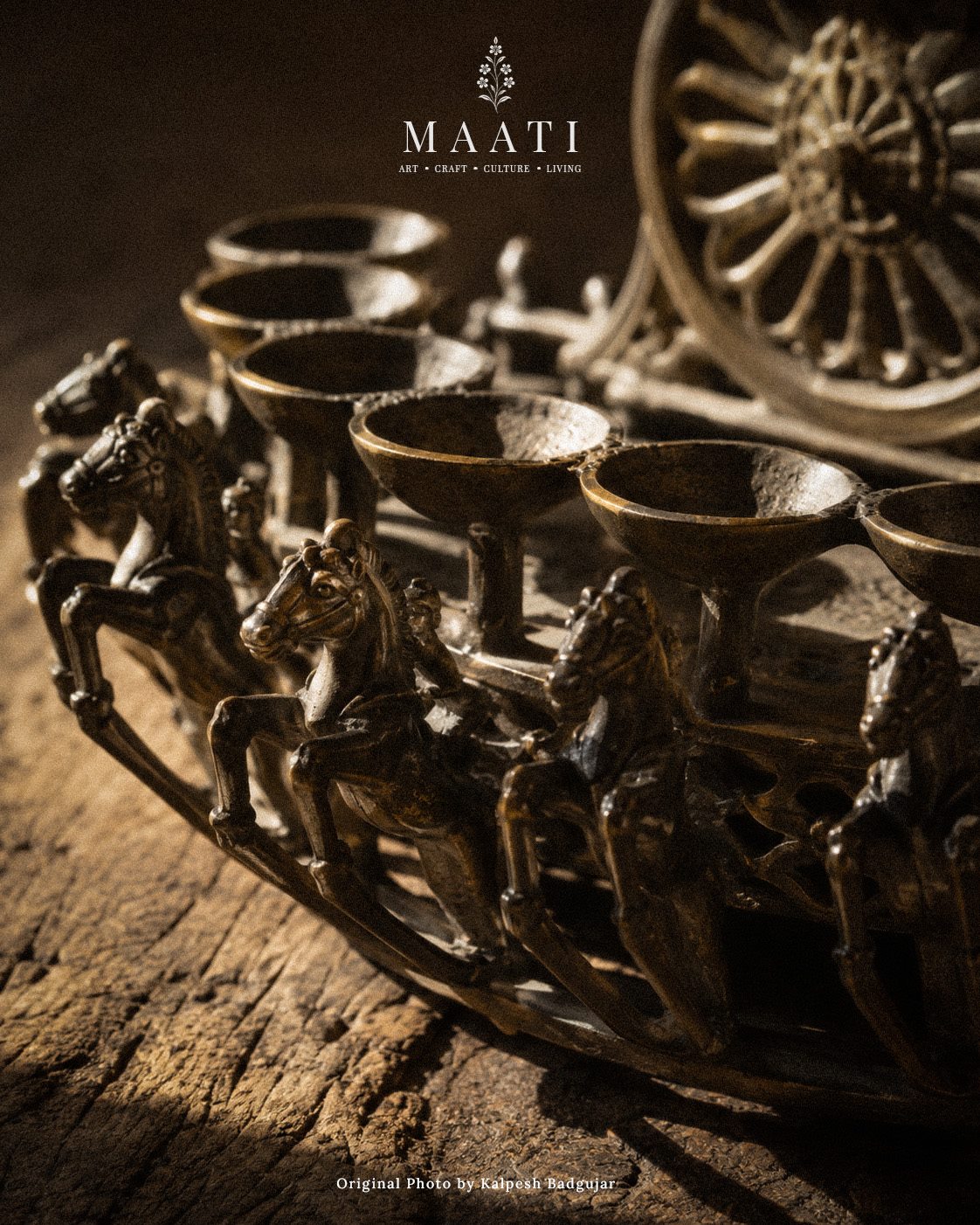 A bronze Surya deep with horses and oil cups in warm light