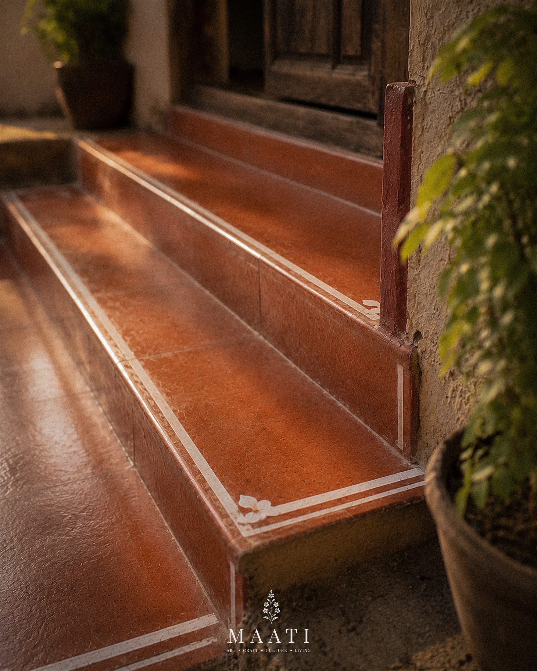 Terracotta steps beside an old wooden door