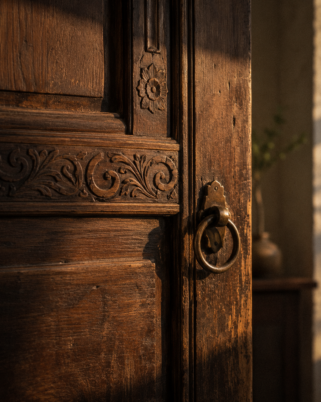 An old carved wooden door glowing in warm evening light